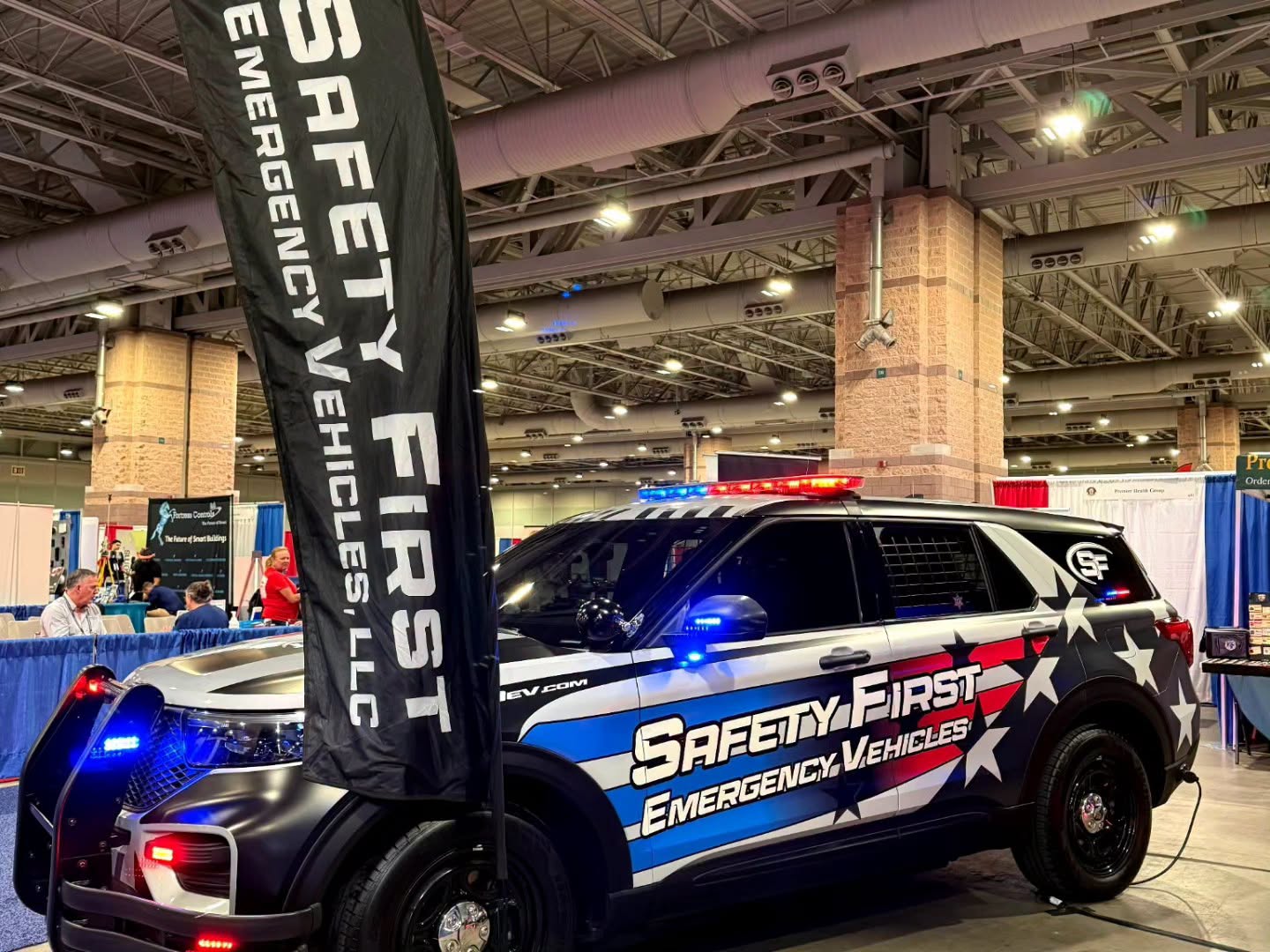 SafetyFirst-built Ford Police Interceptor Utility with full emergency lighting and American-flag graphics on display at the Atlantic City expo.